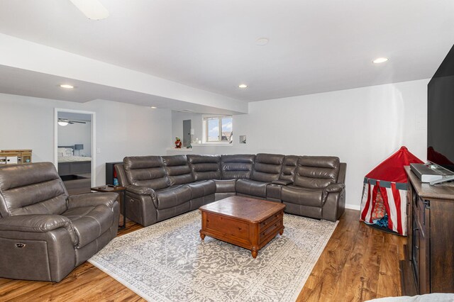 living room featuring ceiling fan and light wood-type flooring