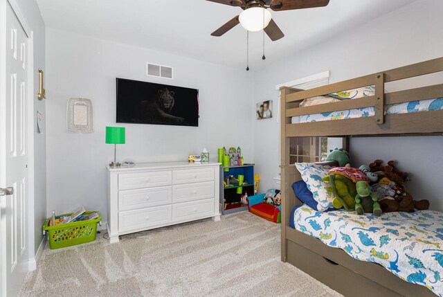 carpeted bedroom with ceiling fan and a closet