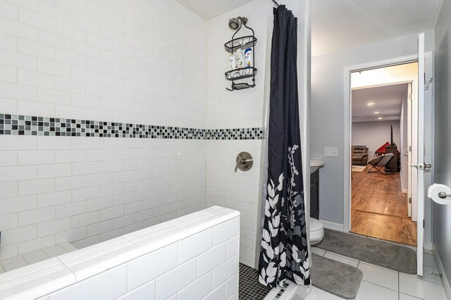 bathroom with tile patterned floors and a shower with shower curtain