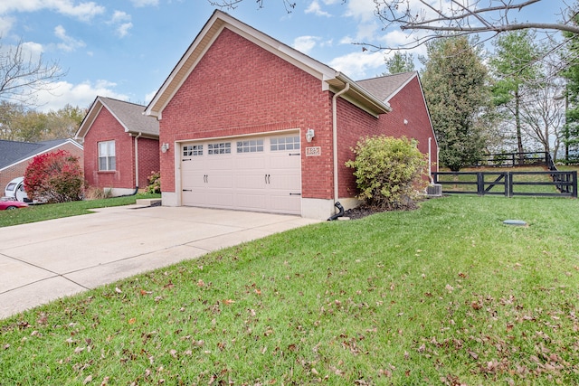 view of home's exterior featuring central air condition unit, a garage, and a lawn