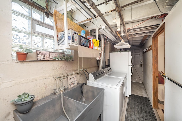 laundry area with a sink and washing machine and clothes dryer