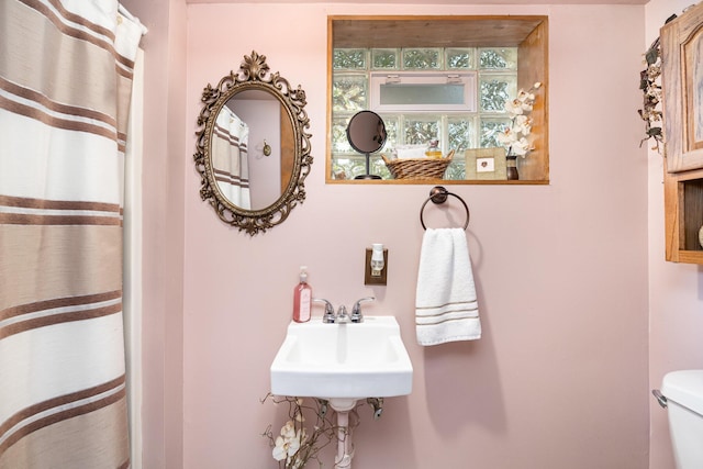 full bath with toilet and a sink