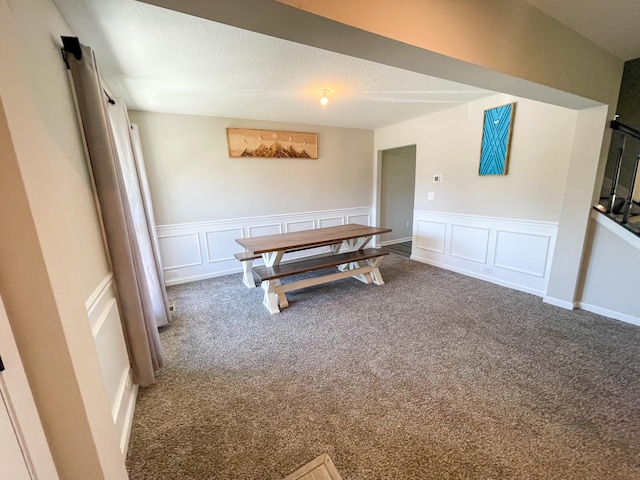 dining space featuring carpet floors and a textured ceiling