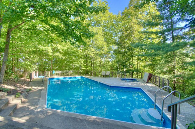 view of swimming pool with a patio