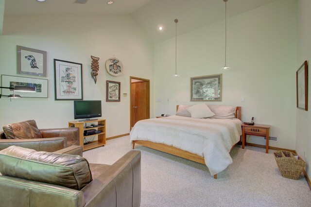 carpeted bedroom featuring high vaulted ceiling