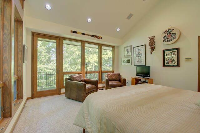 carpeted bedroom with multiple windows, lofted ceiling, and access to exterior