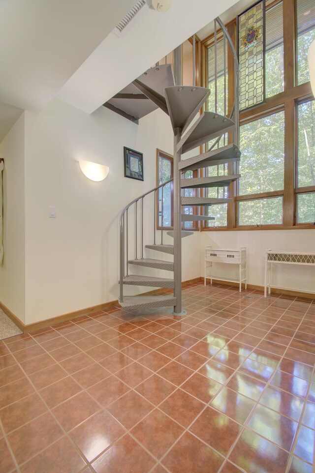 staircase featuring tile patterned flooring