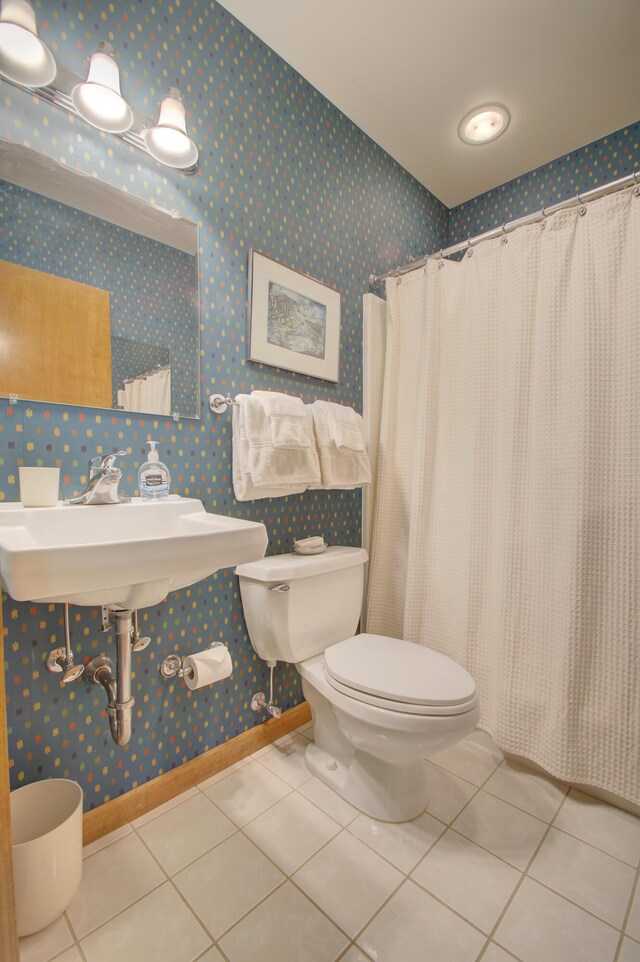 bathroom featuring sink, tile patterned flooring, toilet, and a shower with shower curtain