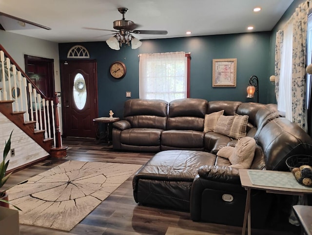 living room with dark wood-type flooring and ceiling fan