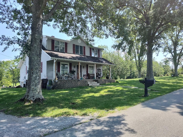 view of front of property with a front lawn and covered porch