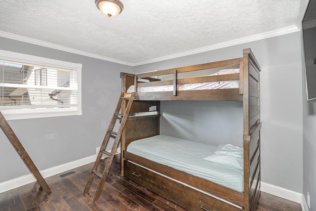 bedroom featuring ornamental molding, dark wood-type flooring, and a textured ceiling