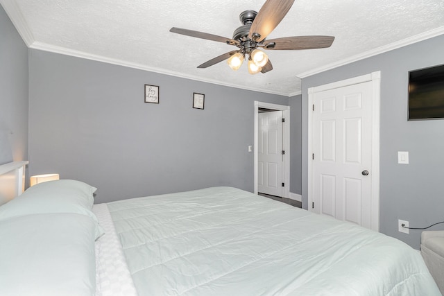 bedroom featuring a closet, ceiling fan, crown molding, and a textured ceiling