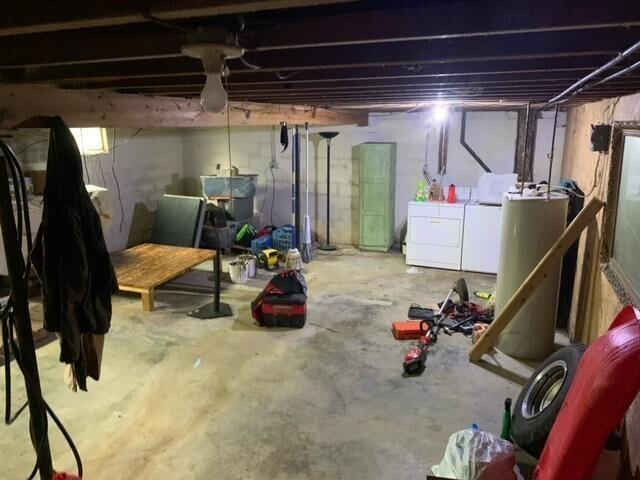 basement with gas water heater and washer and clothes dryer