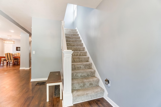 staircase with hardwood / wood-style floors