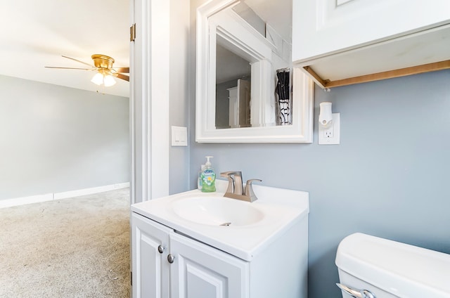 bathroom featuring vanity, toilet, and ceiling fan