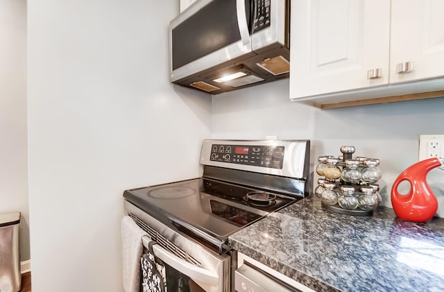 kitchen with appliances with stainless steel finishes and white cabinetry