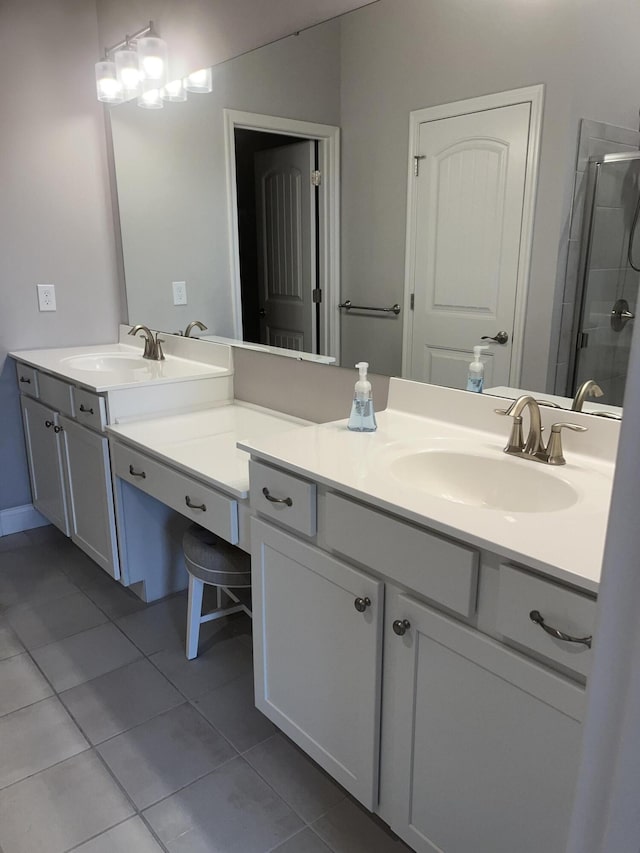 bathroom featuring tile patterned floors, an enclosed shower, and vanity