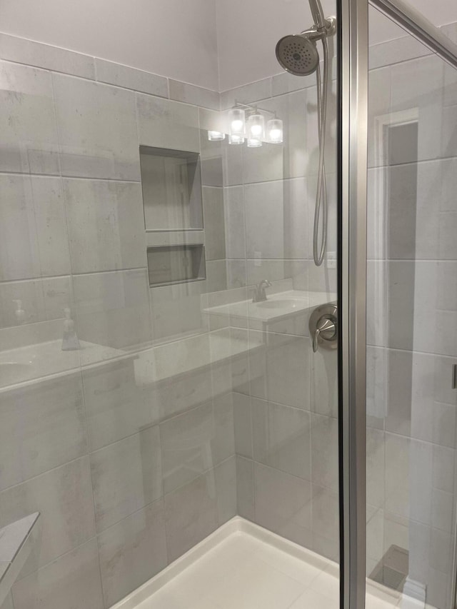 bathroom with a shower with door