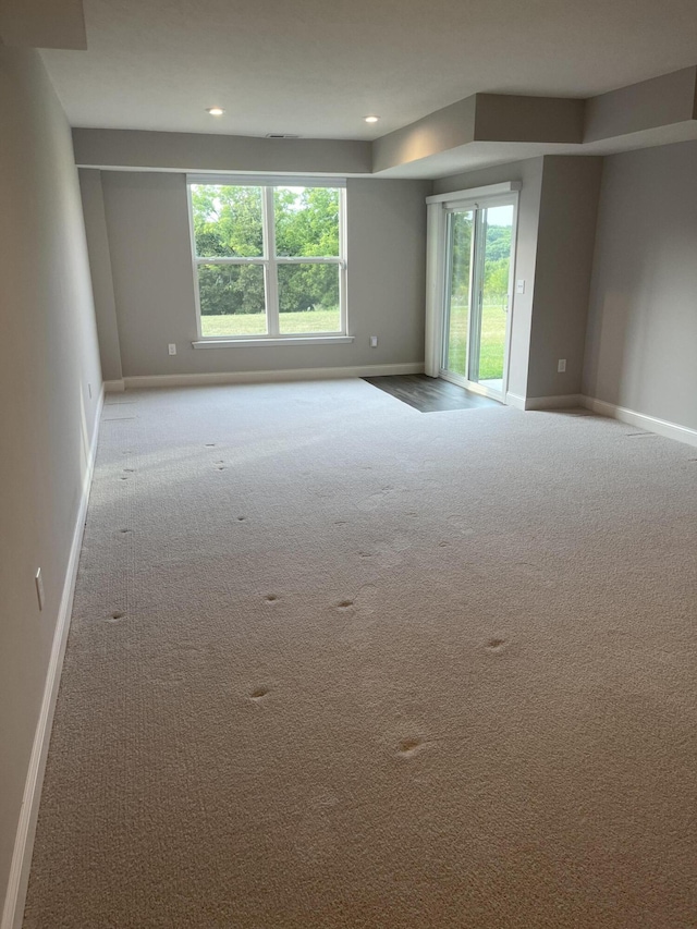 unfurnished room with light colored carpet