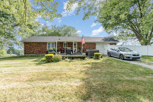 single story home featuring a deck and a front yard