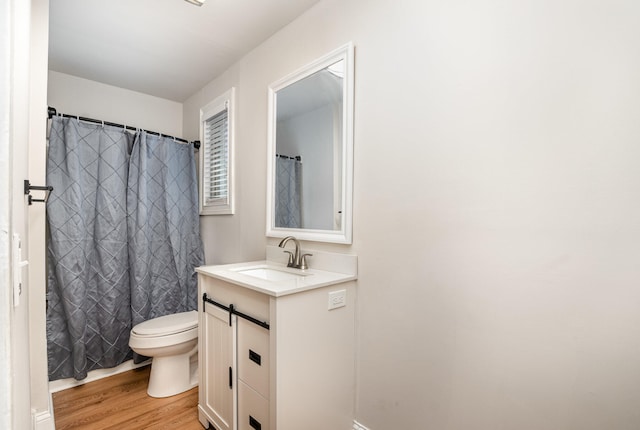 bathroom featuring vanity, toilet, hardwood / wood-style floors, and a shower with shower curtain