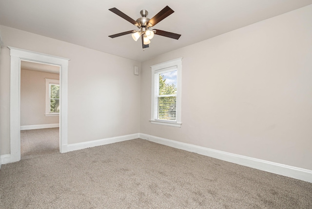 unfurnished room with carpet and ceiling fan