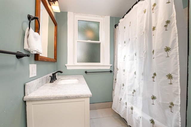 bathroom featuring tile patterned flooring, vanity, and shower / bath combo with shower curtain