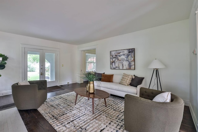 living room with french doors, dark hardwood / wood-style flooring, and plenty of natural light