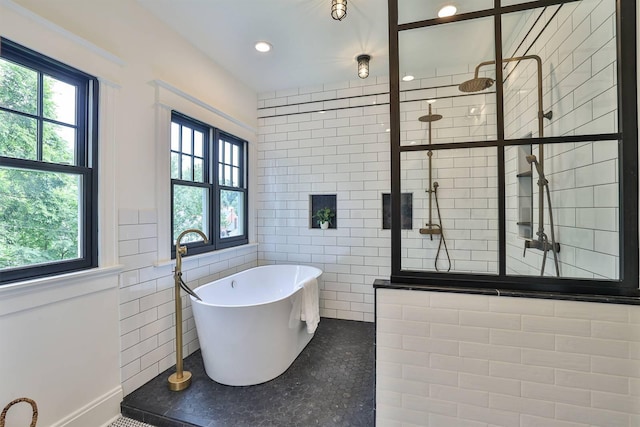 bathroom with tile walls and plus walk in shower