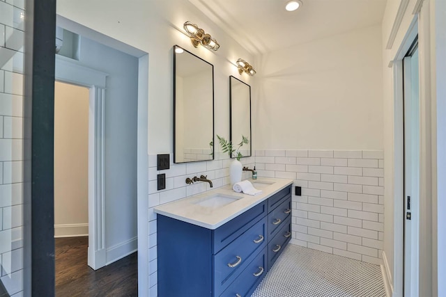 bathroom featuring vanity, tile walls, and wood-type flooring