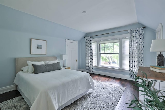 bedroom featuring dark wood-type flooring and lofted ceiling