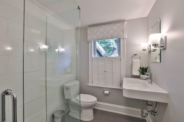 bathroom with toilet and a shower with shower door