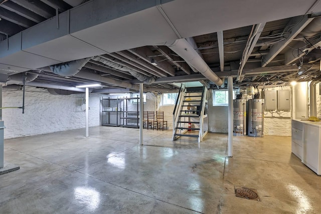 basement featuring gas water heater and separate washer and dryer