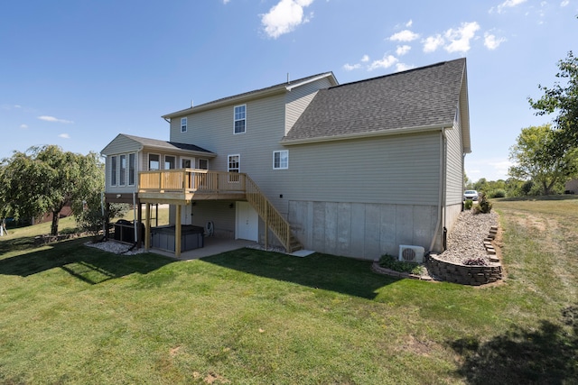 rear view of house featuring a lawn and a deck