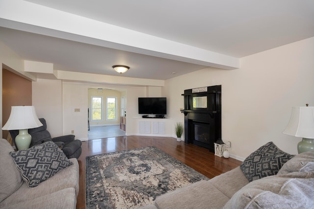 living room featuring dark hardwood / wood-style flooring and beamed ceiling