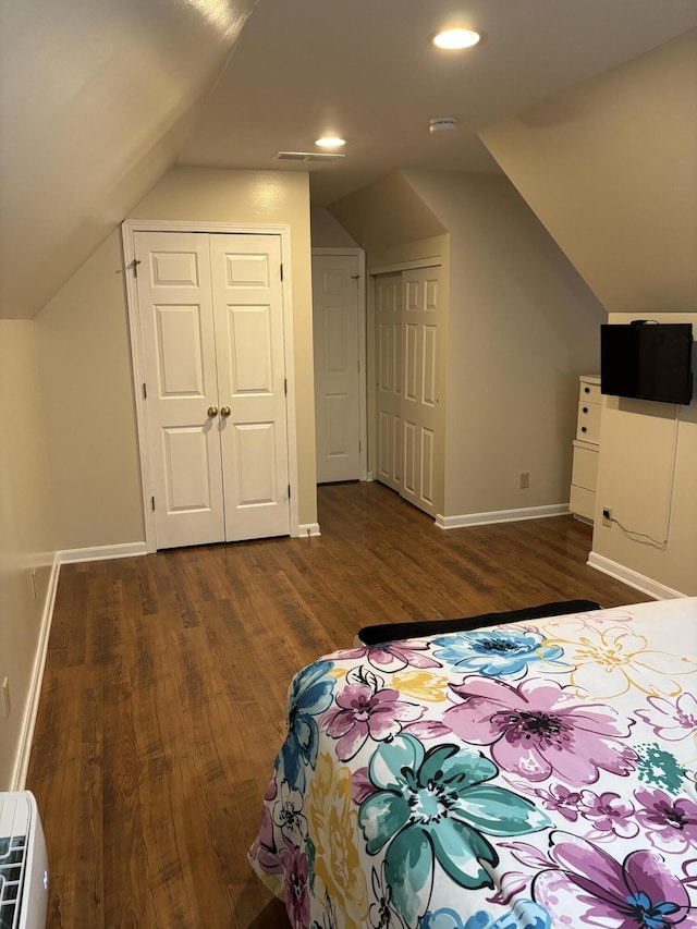 bedroom featuring dark hardwood / wood-style floors and lofted ceiling