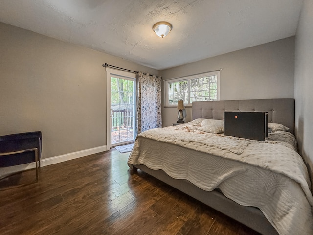 bedroom with dark wood-type flooring and access to exterior