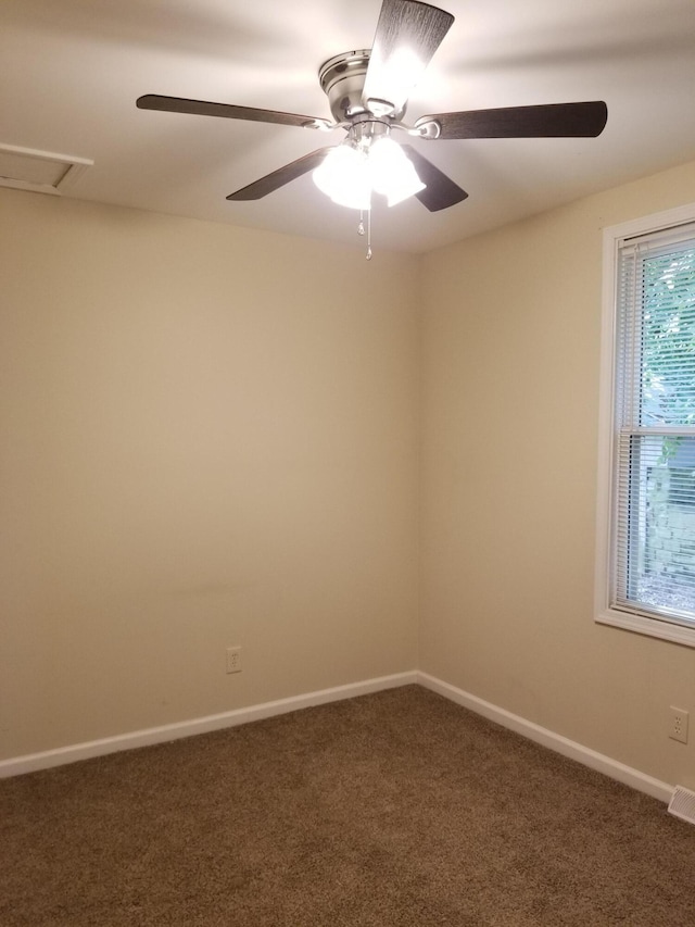 empty room featuring carpet floors and ceiling fan