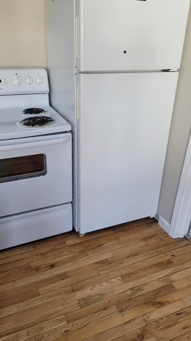 kitchen with white appliances and light wood-type flooring