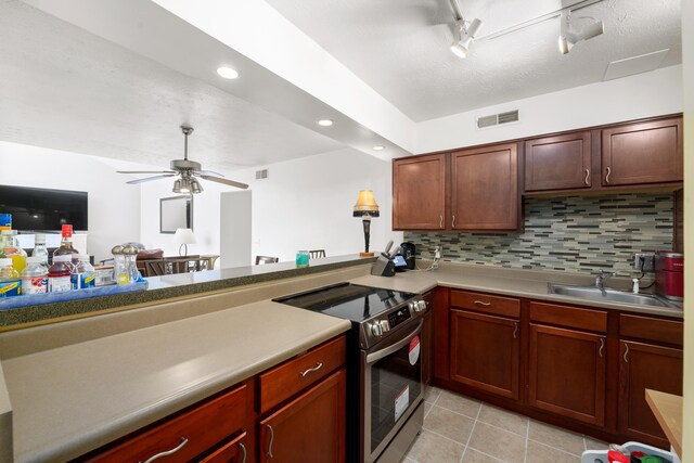 kitchen featuring tasteful backsplash, stainless steel range with electric stovetop, ceiling fan, sink, and light tile patterned floors