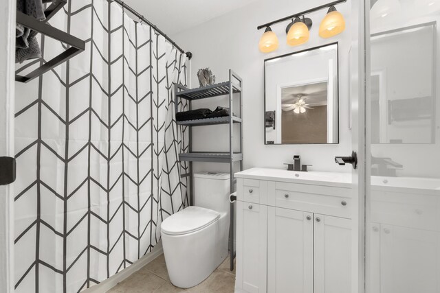 bathroom with tile patterned flooring, vanity, toilet, and a shower with curtain