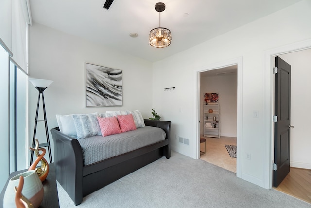 interior space featuring an inviting chandelier and light colored carpet