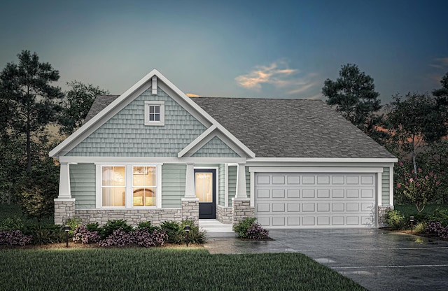 view of front of home with a garage and a yard