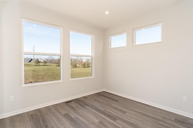 spare room with dark hardwood / wood-style flooring