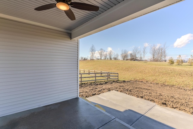 view of patio with ceiling fan and a rural view