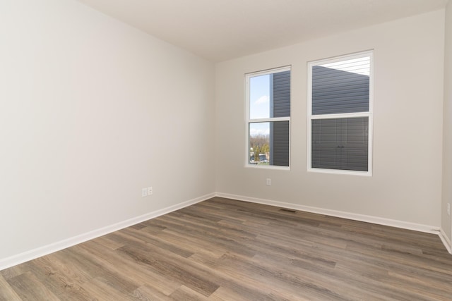 unfurnished room with hardwood / wood-style floors