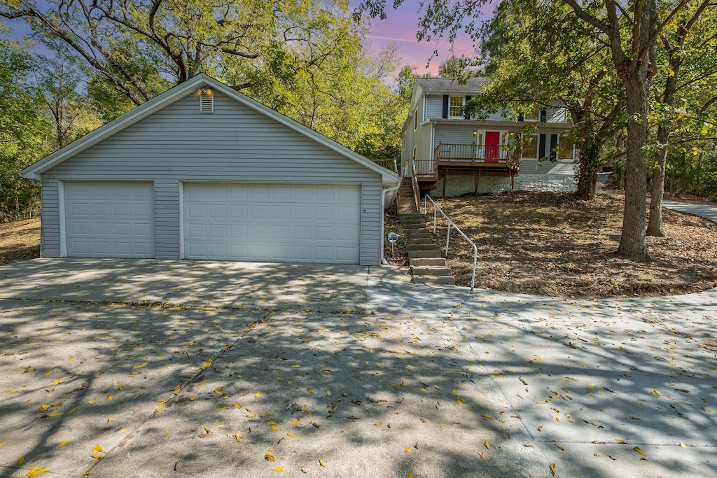 775 Horsebranch Rd, Edgewood, KY 41017 - garage at dusk featuring concrete driveway