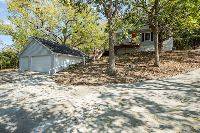 view of property exterior featuring a deck and a garage