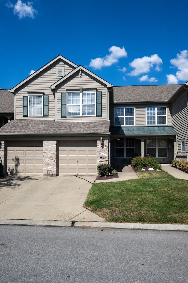 view of front of home with a garage and a front lawn