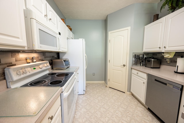 kitchen featuring a textured ceiling, white cabinets, white appliances, and decorative backsplash